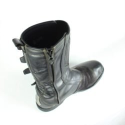 A pair of black ICON ONE THOUSAND 12" full-grain leather motorcycle boots, size 47, in good condition. Features ankle armor, reinforced shifter and shin protection, water-repellent leather, and a Goodyear welt construction. Shows typical wear, a missing screw on a back plaque, and a minor buckle flaw that does not hinder function.