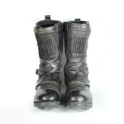 A pair of black ICON ONE THOUSAND 12" full-grain leather motorcycle boots, size 47, in good condition. Features ankle armor, reinforced shifter and shin protection, water-repellent leather, and a Goodyear welt construction. Shows typical wear, a missing screw on a back plaque, and a minor buckle flaw that does not hinder function.