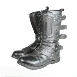 A pair of black ICON ONE THOUSAND 12" full-grain leather motorcycle boots, size 47, in good condition. Features ankle armor, reinforced shifter and shin protection, water-repellent leather, and a Goodyear welt construction. Shows typical wear, a missing screw on a back plaque, and a minor buckle flaw that does not hinder function.