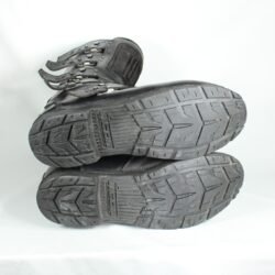 A pair of black ICON ONE THOUSAND 12" full-grain leather motorcycle boots, size 47, in good condition. Features ankle armor, reinforced shifter and shin protection, water-repellent leather, and a Goodyear welt construction. Shows typical wear, a missing screw on a back plaque, and a minor buckle flaw that does not hinder function.