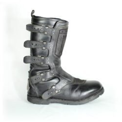 A pair of black ICON ONE THOUSAND 12" full-grain leather motorcycle boots, size 47, in good condition. Features ankle armor, reinforced shifter and shin protection, water-repellent leather, and a Goodyear welt construction. Shows typical wear, a missing screw on a back plaque, and a minor buckle flaw that does not hinder function.