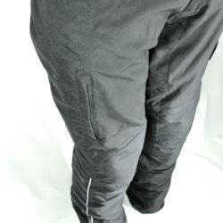 A pair of black DXR waterproof textile motorcycle pants, size M (48/50, 85 cm waist), in very good condition. Features a Klima-Membrane for all-weather touring, knee protectors, reflectors, waist adjustment, and a short jacket connection zipper.