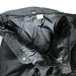 A pair of black DXR waterproof textile motorcycle pants, size M (48/50, 85 cm waist), in very good condition. Features a Klima-Membrane for all-weather touring, knee protectors, reflectors, waist adjustment, and a short jacket connection zipper.