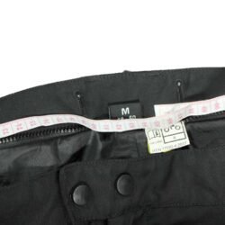 A pair of black DXR waterproof textile motorcycle pants, size M (48/50, 85 cm waist), in very good condition. Features a Klima-Membrane for all-weather touring, knee protectors, reflectors, waist adjustment, and a short jacket connection zipper.