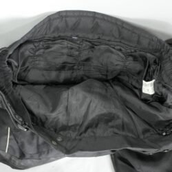 A pair of black Geneze waterproof textile motorcycle pants, size 2XL (96 cm stretch waist), in good condition. Features a Reissa-membrane, knee protectors, multiple adjustment points, reflective details, and leather reinforcements for durability.