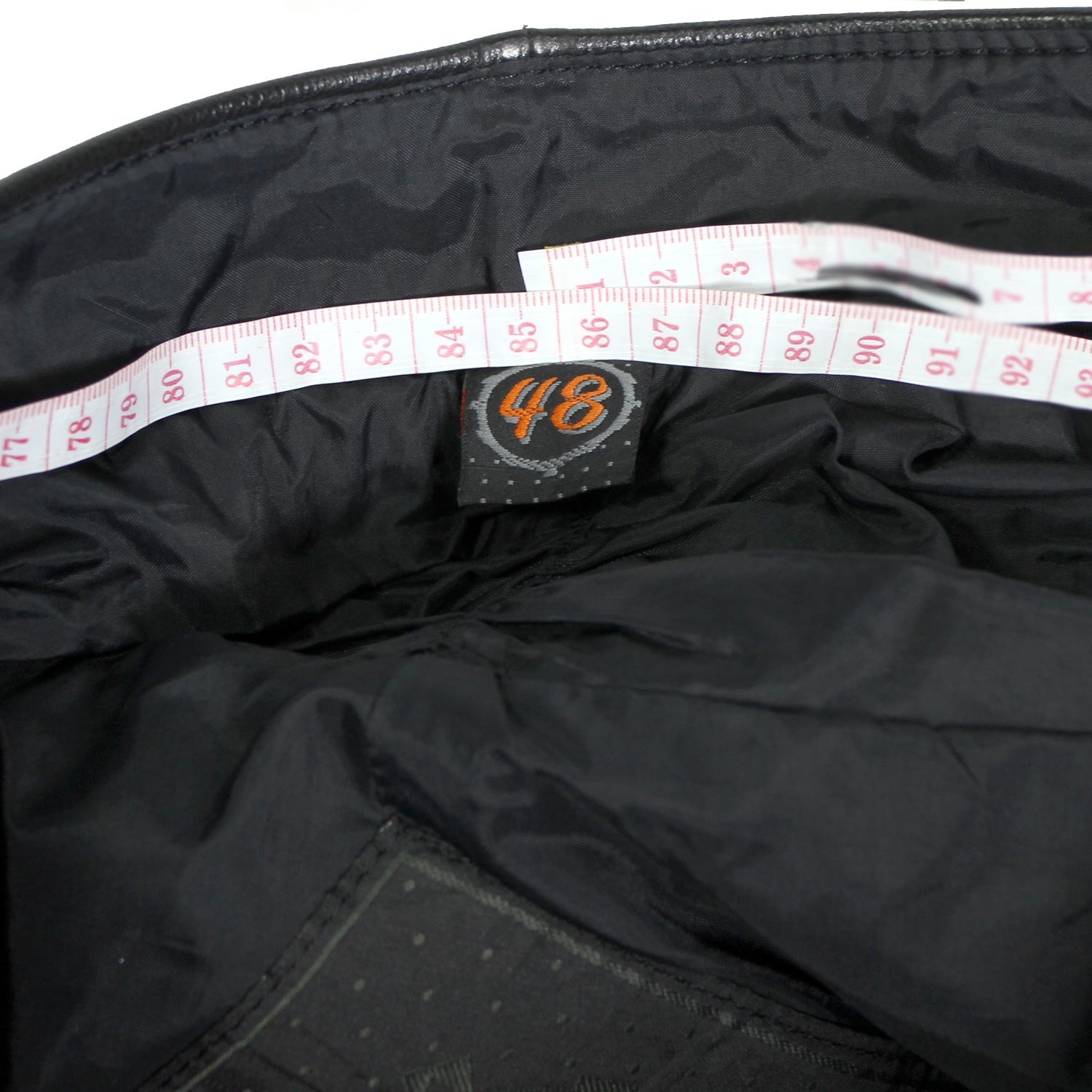 A pair of black Hein Gericke Streetline leather motorcycle pants, size 48 (85 cm waist), in good condition. Features a classic café-racer style with foam knee protectors. Hip protectors have been removed, leaving visible stitch holes but not affecting function.