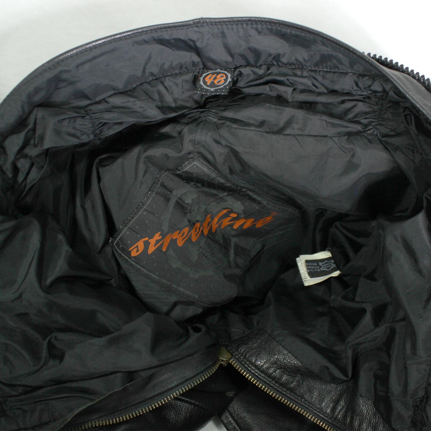 A pair of black Hein Gericke Streetline leather motorcycle pants, size 48 (85 cm waist), in good condition. Features a classic café-racer style with foam knee protectors. Hip protectors have been removed, leaving visible stitch holes but not affecting function.