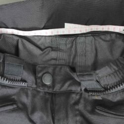 A pair of black IXS waterproof textile motorcycle pants, size L (91 cm stretch waist), in like-new condition. Features a Gore-Tex membrane, knee and hip protectors, and a full-length connection zipper for a riding jacket.