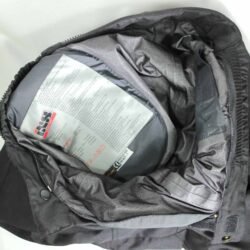 A pair of black IXS waterproof textile motorcycle pants, size L (91 cm stretch waist), in like-new condition. Features a Gore-Tex membrane, knee and hip protectors, and a full-length connection zipper for a riding jacket.