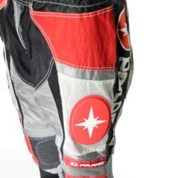 A pair of Polaris Cross motorcycle pants in black, red, and grey, size XL (96 cm stretch waist), in good condition. Features a motocross-style textile construction with integrated knee protectors.