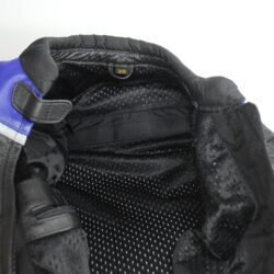 A black and blue Competition R by Polo women's leather racing jacket, size 36, in very good condition. Features a snug track-focused fit, shoulder, elbow, and back protectors, reflective stripes, and a full jacket-to-pants connection zipper.