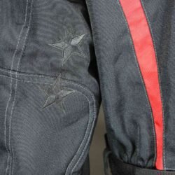 A black and red Probiker waterproof and breathable touring and adventure jacket, size M, in good condition. Features a climate membrane and shoulder protectors. Shows wear and includes professional repair patches in some areas (see product photos)