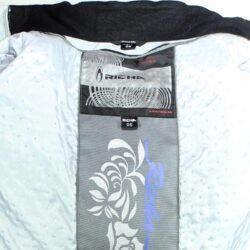 A light grey Richa all-weather women's motorcycle jacket, size S, in very good condition. Features a waterproof textile shell, removable thermal liner, removable hood with faux fur, and CE protection at shoulders, elbows, and back. Suitable for riders and passengers.