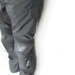 A pair of black Vanucci waterproof touring and adventure motorcycle trousers, size L (100 cm waist), in very good condition. Made of durable textile with a SympaTex membrane, includes knee protectors, and features both short and full-length jacket connection zippers.