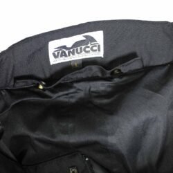 A pair of black Vanucci waterproof touring and adventure motorcycle trousers, size L (100 cm waist), in very good condition. Made of durable textile with a SympaTex membrane, includes knee protectors, and features both short and full-length jacket connection zippers.