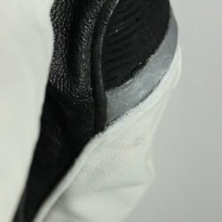 A black and white Alpinestars Jaws sport racing leather jacket, size 56 (XL-XXL, 110-114 cm chest), in good condition. Features premium perforated full-grain leather, CE-certified shoulder, elbow, and back protectors, a removable thermal liner, and adjustable fit with professional repairs visible.