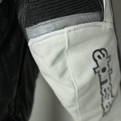 A black and white Alpinestars Jaws sport racing leather jacket, size 56 (XL-XXL, 110-114 cm chest), in good condition. Features premium perforated full-grain leather, CE-certified shoulder, elbow, and back protectors, a removable thermal liner, and adjustable fit with professional repairs visible.