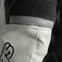 A black and white Alpinestars Jaws sport racing leather jacket, size 56 (XL-XXL, 110-114 cm chest), in good condition. Features premium perforated full-grain leather, CE-certified shoulder, elbow, and back protectors, a removable thermal liner, and adjustable fit with professional repairs visible.