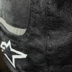 A black and white Alpinestars Jaws sport racing leather jacket, size 56 (XL-XXL, 110-114 cm chest), in good condition. Features premium perforated full-grain leather, CE-certified shoulder, elbow, and back protectors, a removable thermal liner, and adjustable fit with professional repairs visible.