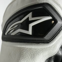 A black and white Alpinestars Jaws sport racing leather jacket, size 56 (XL-XXL, 110-114 cm chest), in good condition. Features premium perforated full-grain leather, CE-certified shoulder, elbow, and back protectors, a removable thermal liner, and adjustable fit with professional repairs visible.