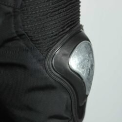 A black and red Furygan Titan sport racing textile jacket, size XL (105-112 cm chest), in good condition. Features a waterproof climate membrane, removable CE-approved D3O protectors at shoulders, elbows, and back, aluminum impact reinforcements, and a removable quilted thermal liner.