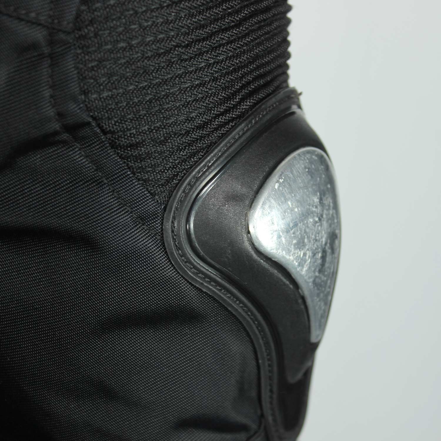 A black and red Furygan Titan sport racing textile jacket, size XL (105-112 cm chest), in good condition. Features a waterproof climate membrane, removable CE-approved D3O protectors at shoulders, elbows, and back, aluminum impact reinforcements, and a removable quilted thermal liner.