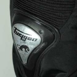 A black and red Furygan Titan sport racing textile jacket, size XL (105-112 cm chest), in good condition. Features a waterproof climate membrane, removable CE-approved D3O protectors at shoulders, elbows, and back, aluminum impact reinforcements, and a removable quilted thermal liner.