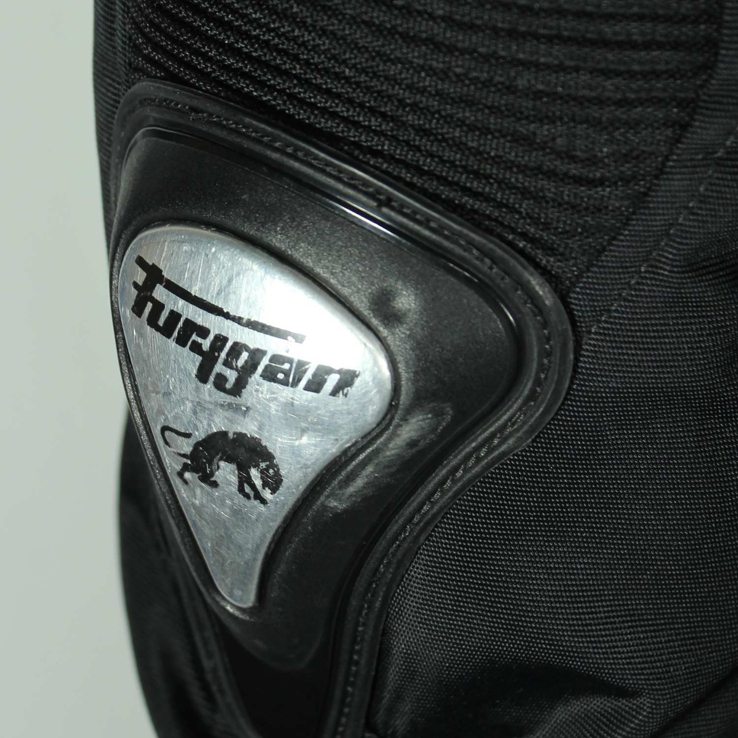 A black and red Furygan Titan sport racing textile jacket, size XL (105-112 cm chest), in good condition. Features a waterproof climate membrane, removable CE-approved D3O protectors at shoulders, elbows, and back, aluminum impact reinforcements, and a removable quilted thermal liner.