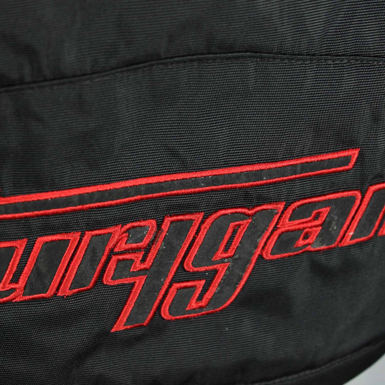 A black and red Furygan Titan sport racing textile jacket, size XL (105-112 cm chest), in good condition. Features a waterproof climate membrane, removable CE-approved D3O protectors at shoulders, elbows, and back, aluminum impact reinforcements, and a removable quilted thermal liner.