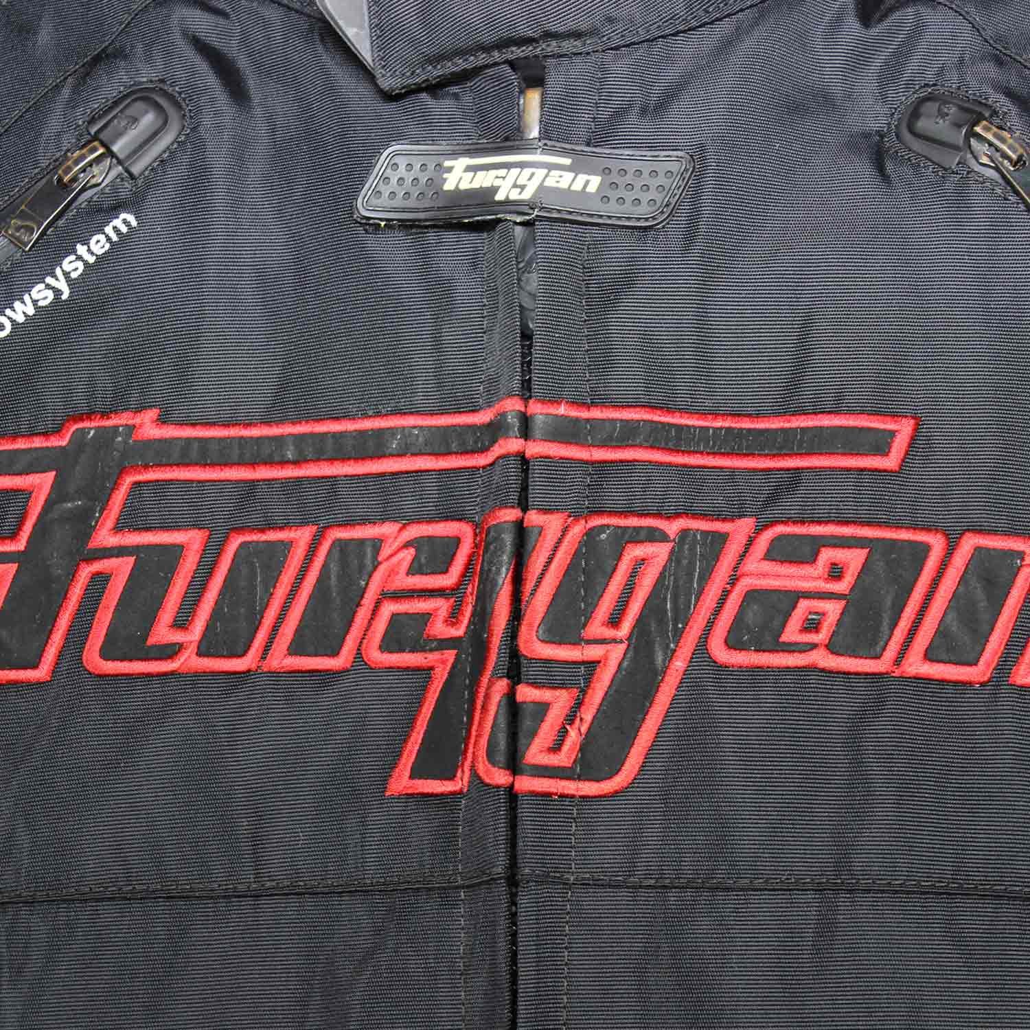 A black and red Furygan Titan sport racing textile jacket, size XL (105-112 cm chest), in good condition. Features a waterproof climate membrane, removable CE-approved D3O protectors at shoulders, elbows, and back, aluminum impact reinforcements, and a removable quilted thermal liner.