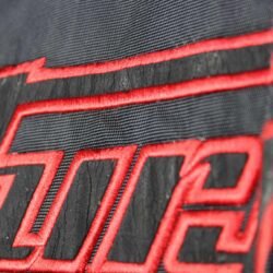 A black and red Furygan Titan sport racing textile jacket, size XL (105-112 cm chest), in good condition. Features a waterproof climate membrane, removable CE-approved D3O protectors at shoulders, elbows, and back, aluminum impact reinforcements, and a removable quilted thermal liner.