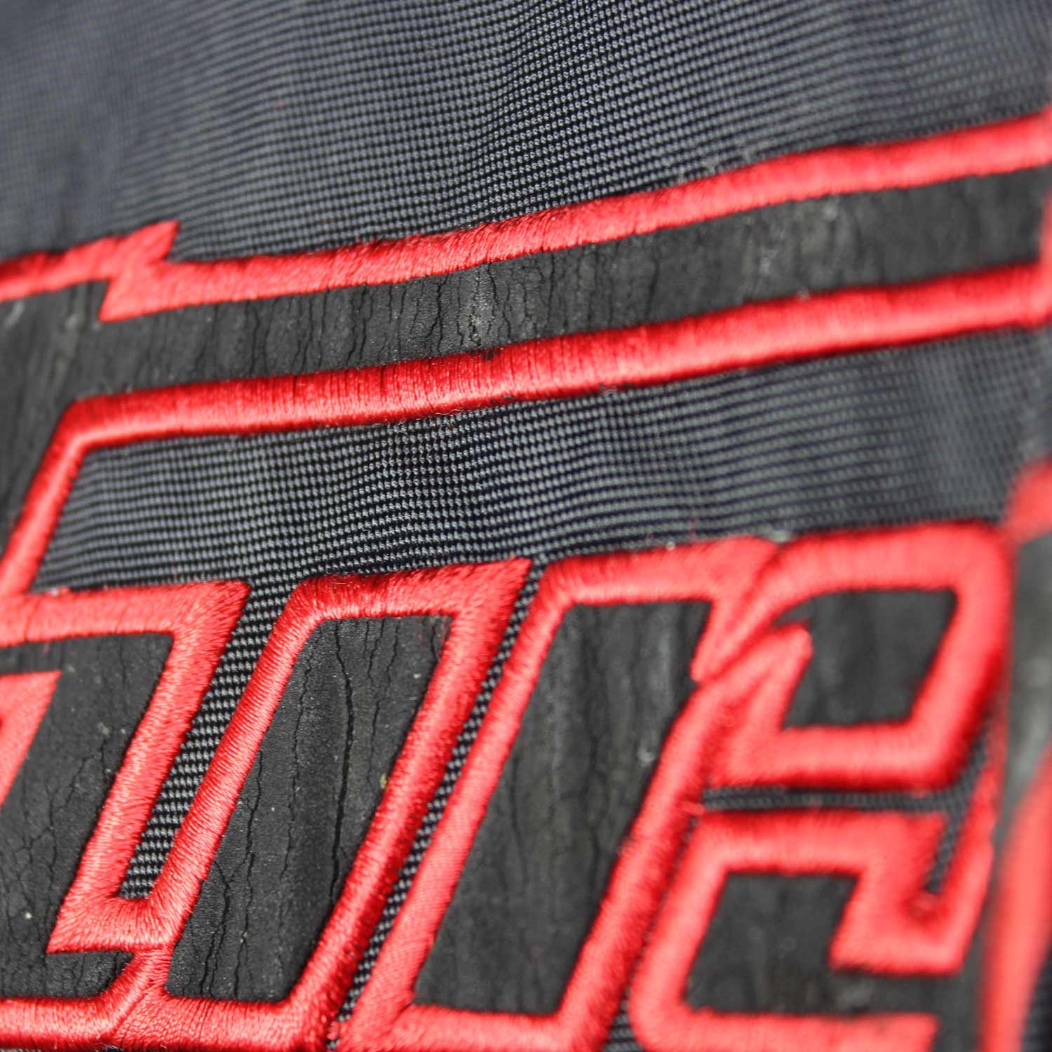 A black and red Furygan Titan sport racing textile jacket, size XL (105-112 cm chest), in good condition. Features a waterproof climate membrane, removable CE-approved D3O protectors at shoulders, elbows, and back, aluminum impact reinforcements, and a removable quilted thermal liner.
