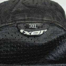 A black Ixon Hacker summer mesh motorcycle jacket, size 3XL, in very good condition. Features Spylex polyester construction with extensive mesh panels for ventilation, CE-certified shoulder and elbow protectors, a back protector, and multiple adjustments for a custom fit.