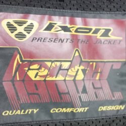 A black Ixon Hacker summer mesh motorcycle jacket, size 3XL, in very good condition. Features Spylex polyester construction with extensive mesh panels for ventilation, CE-certified shoulder and elbow protectors, a back protector, and multiple adjustments for a custom fit.